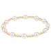 Pearl and gold beaded bracelet on a white background