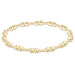 Gold beaded bracelet on a white background