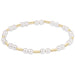 Pearl bracelet with gold accents on a white background