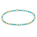 Turquoise and gold beaded bracelet on a white background
