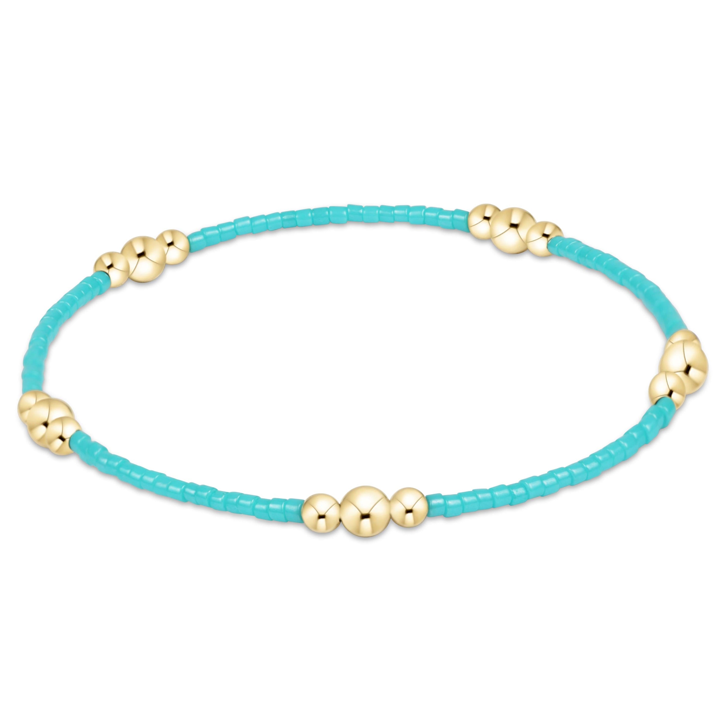 Turquoise bracelet with gold beads on a white background
