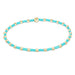 Beaded necklace with turquoise and gold beads on a white background