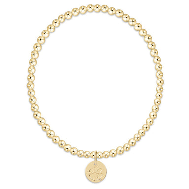 Gold beaded bracelet with a round tag on a white background