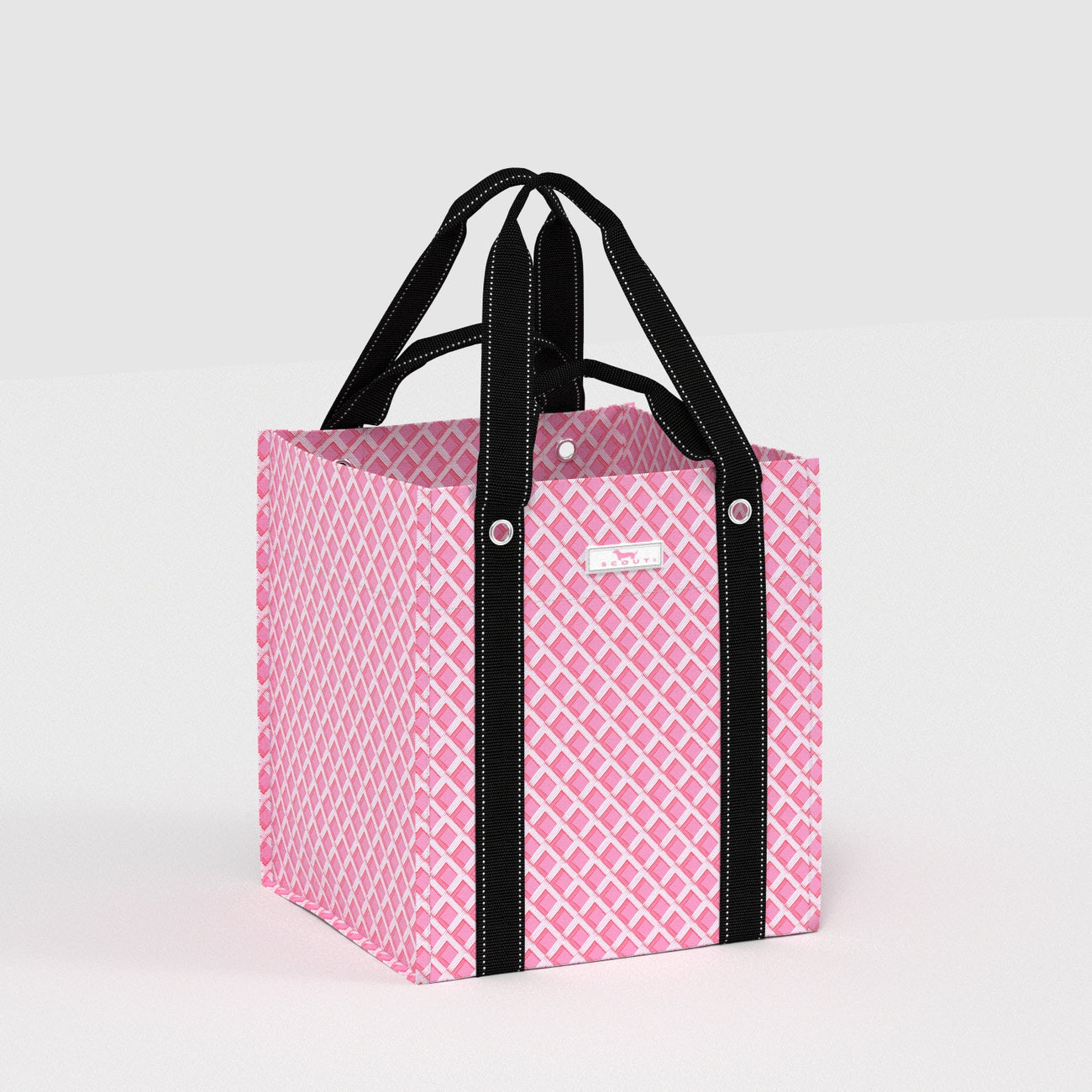 Pink patterned tote bag with black handles on a light gray background