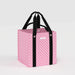 Pink patterned tote bag with black handles on a light gray background