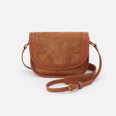 Brown suede handbag with decorative stitching on a white background