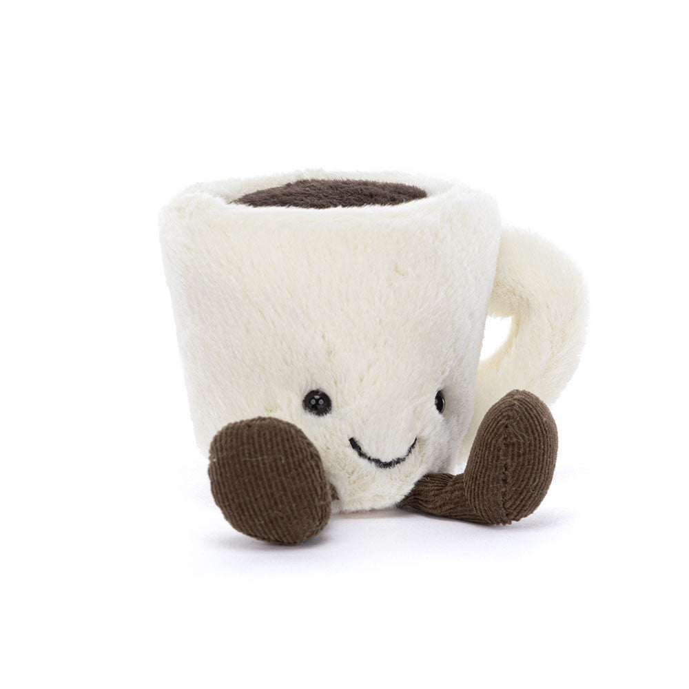 Knitted mug-shaped plush toy with a smiling face on a white background