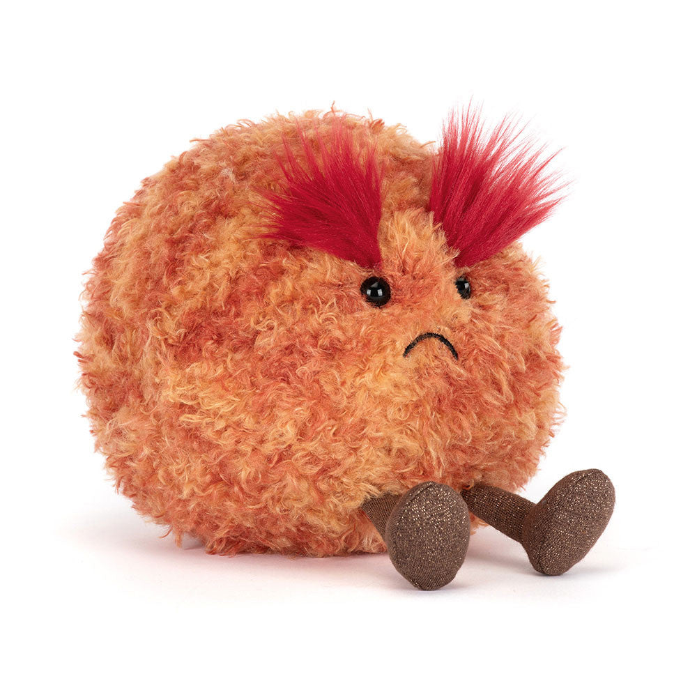 Plush toy resembling a round creature with red hair on a white background