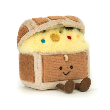 A plush toy resembling a smiling treasure chest with multicolored contents inside.