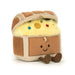 A plush toy resembling a smiling treasure chest with multicolored contents inside.