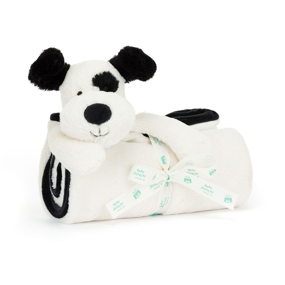 White plush dog toy with black spots and a bow on a white background