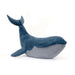 Blue plush whale toy on a white background