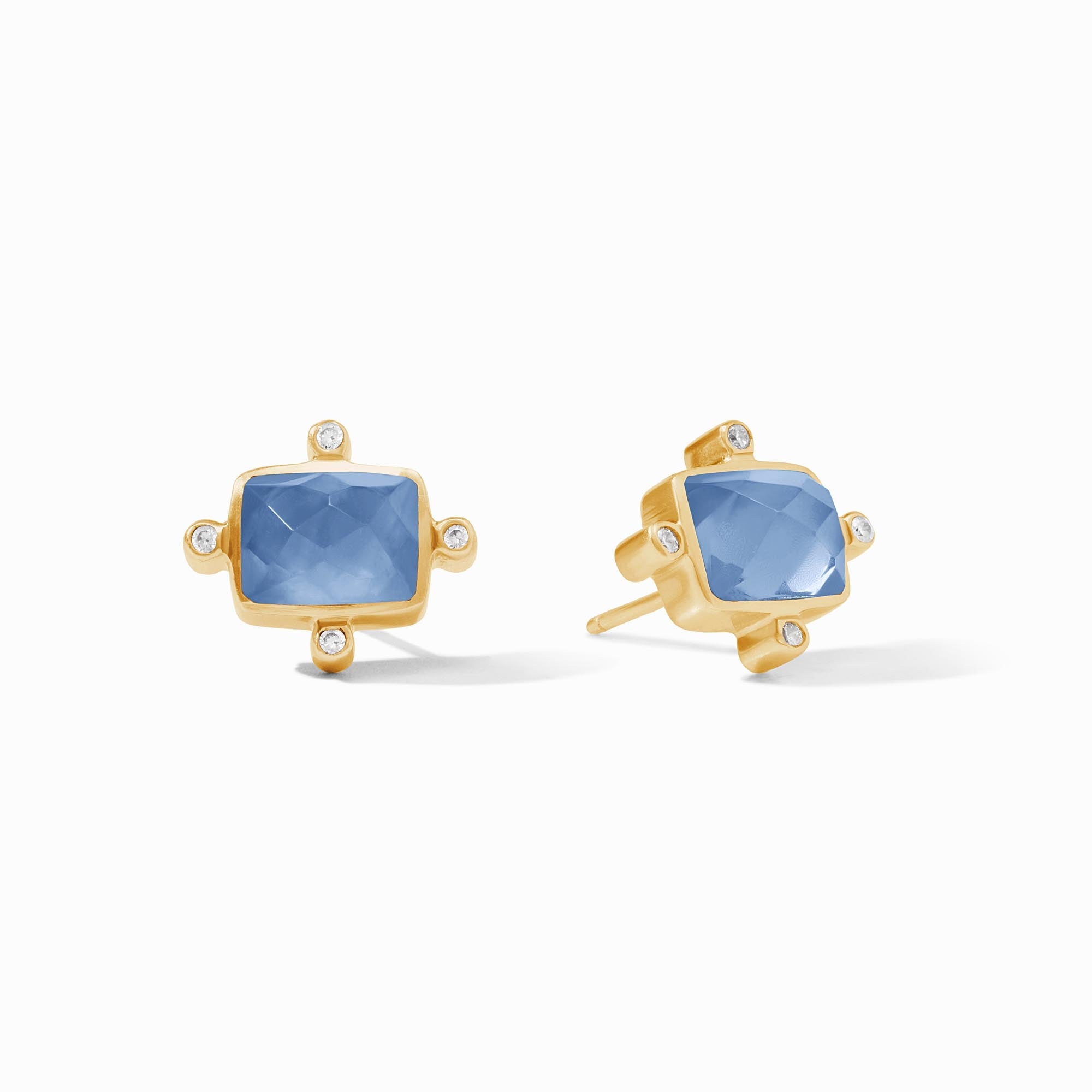 Gold earrings with blue gemstones on a white background