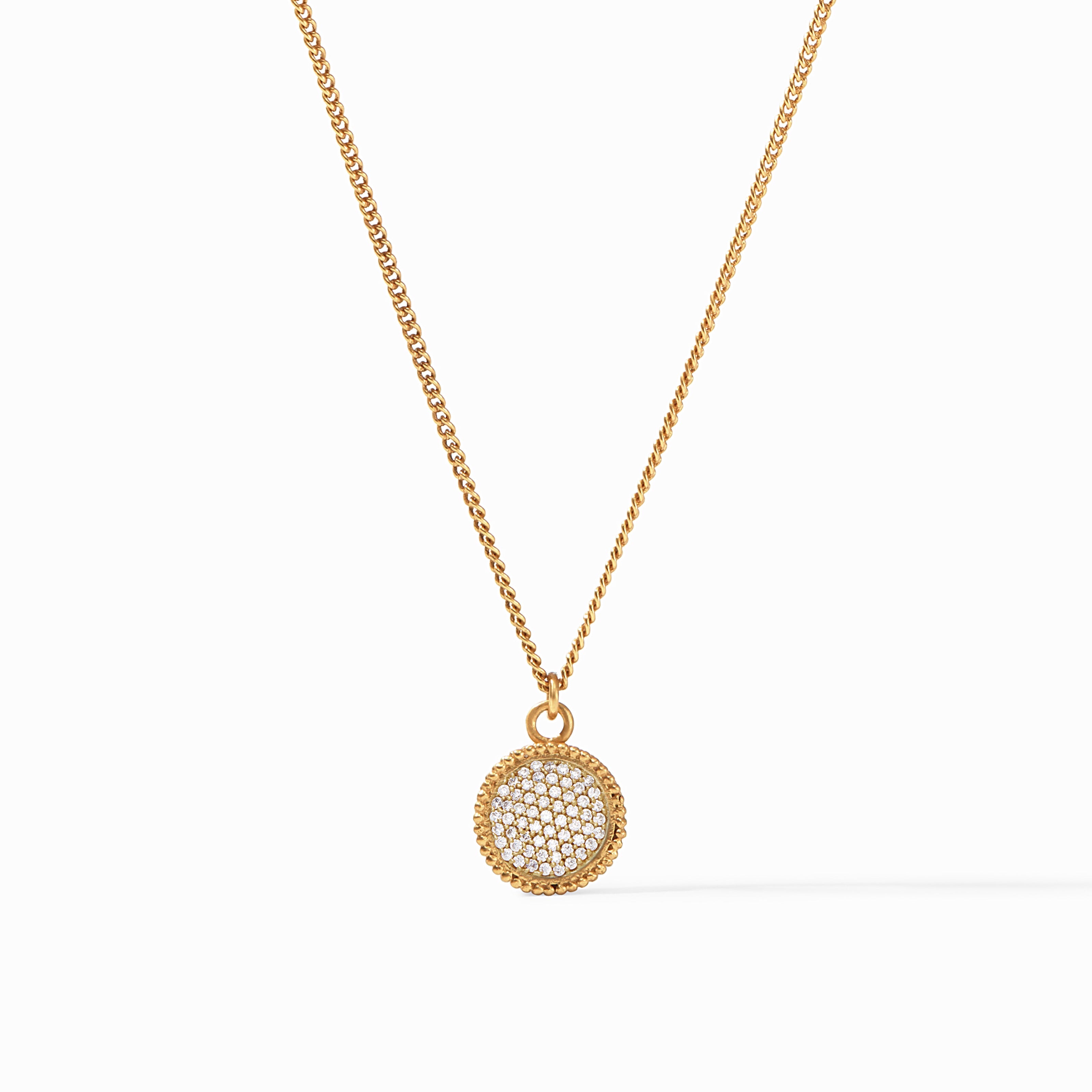 Gold necklace with a round pendant on a white background
