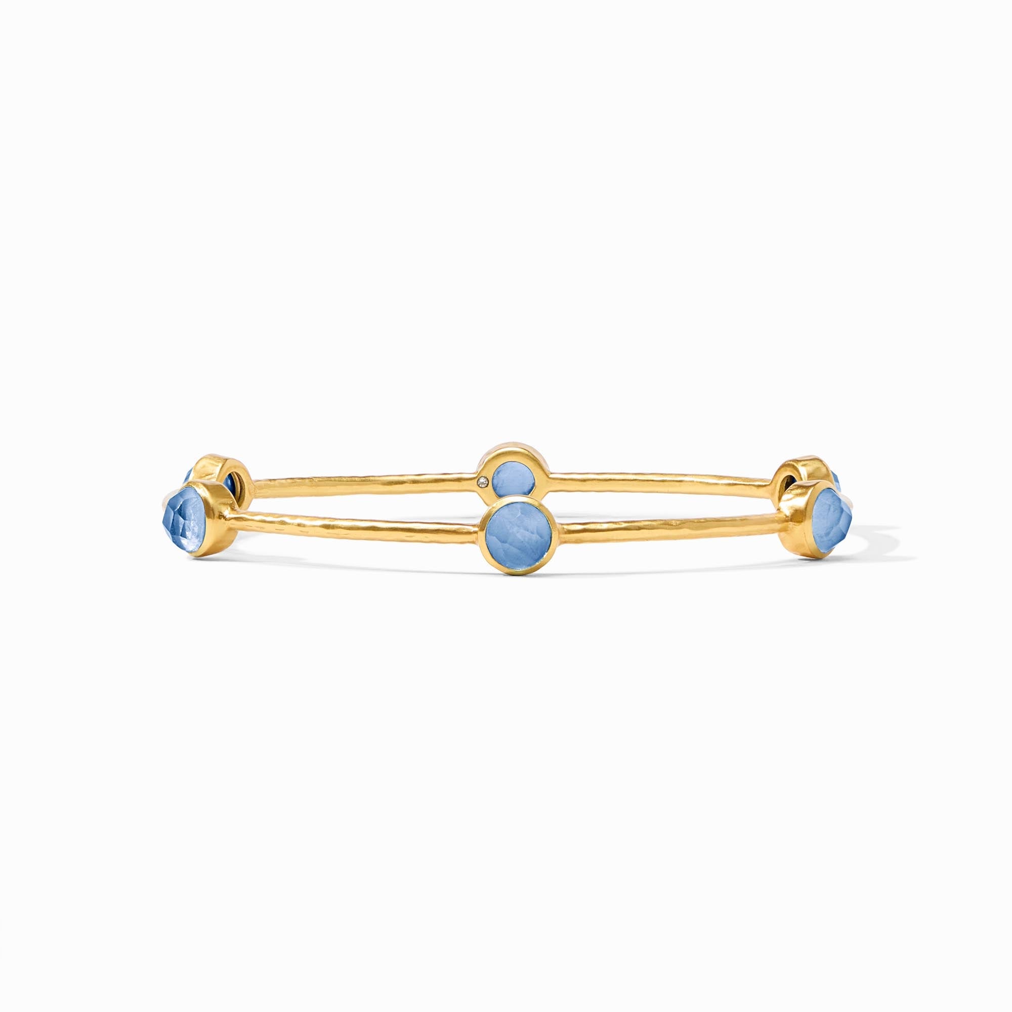 Gold bracelet with blue stones on a white background