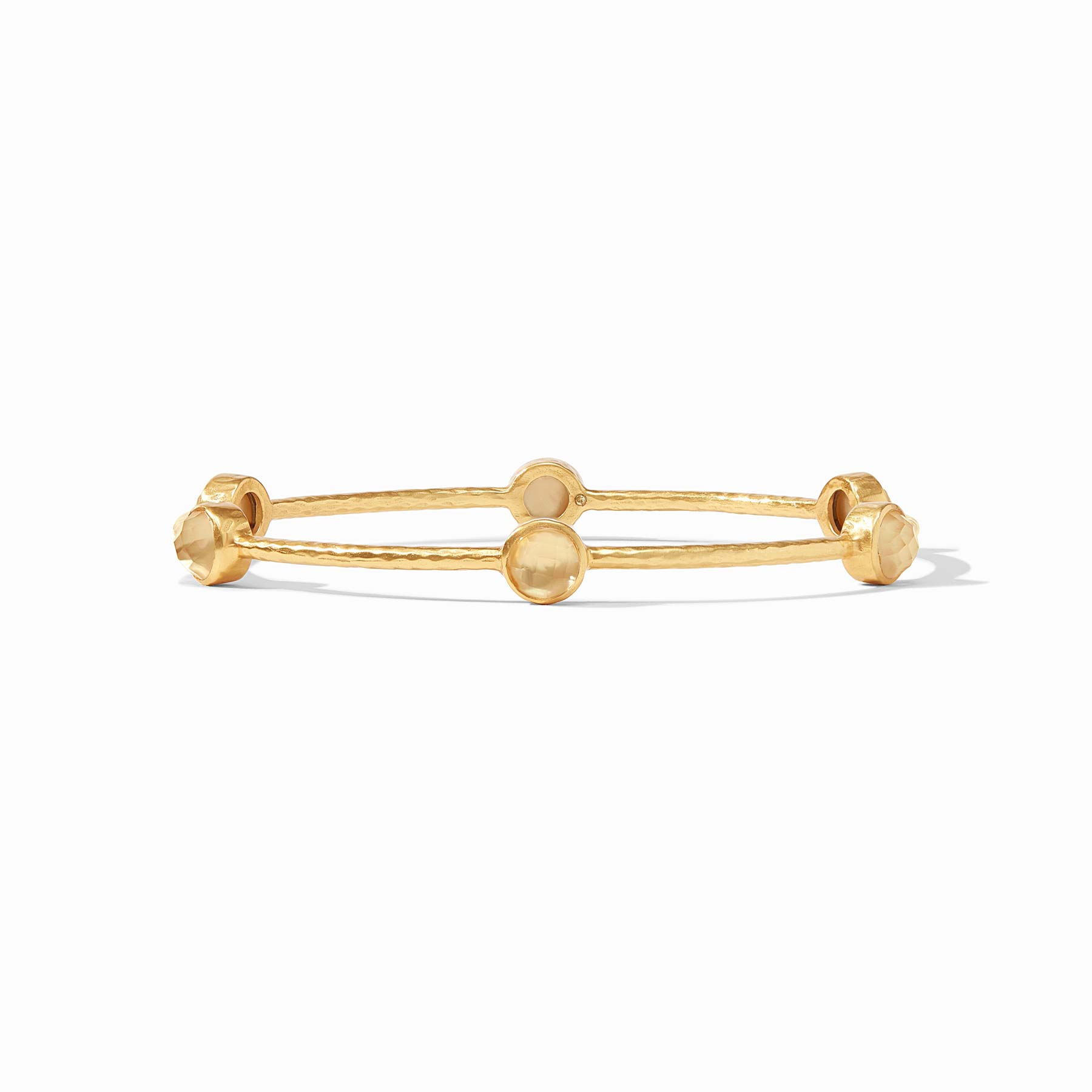 Gold ring with spherical beads on a white background