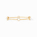 Gold bracelet with pearl-like beads on a white background