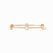 Gold bracelet with three pearl-like beads on a white background