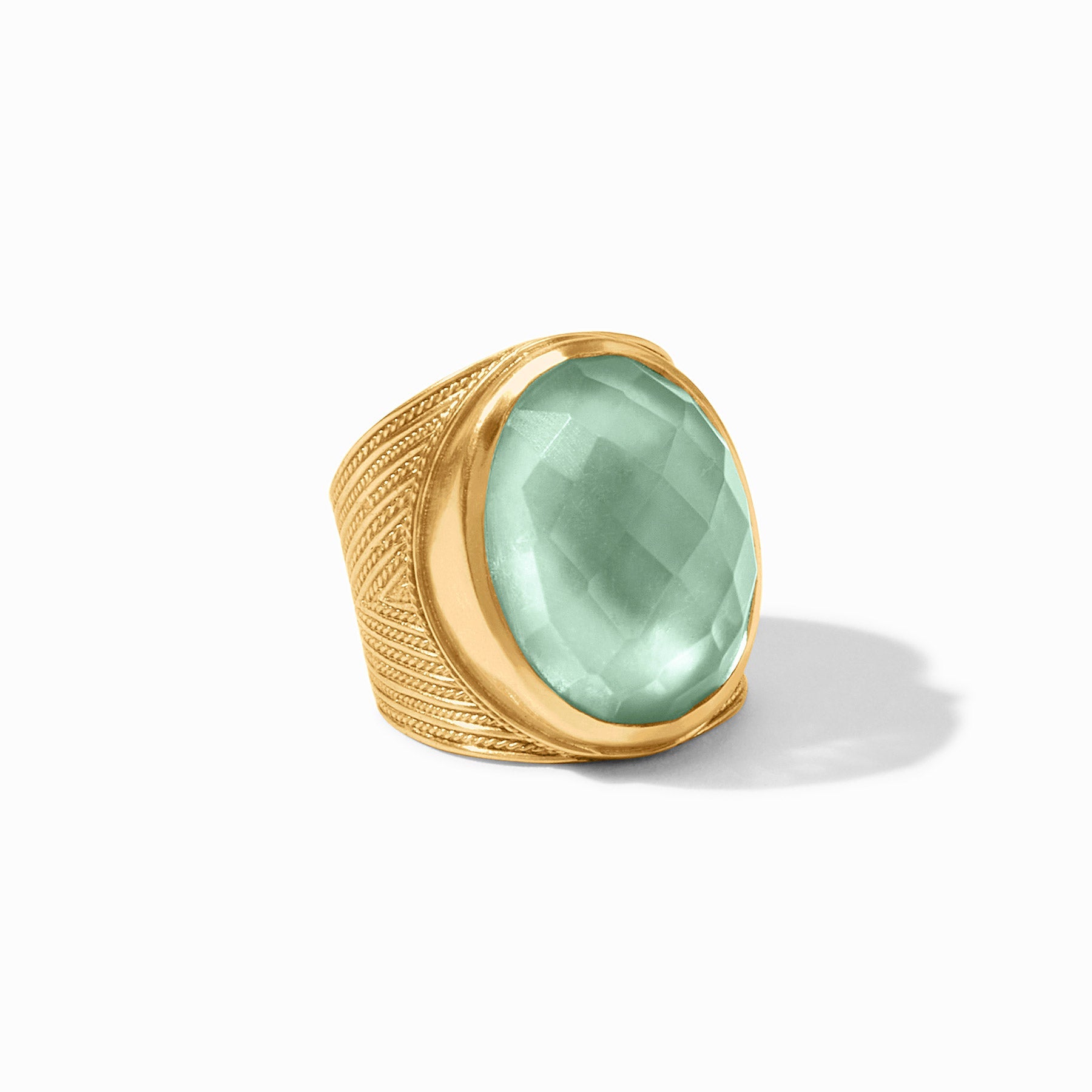 Gold ring with a green gemstone on a white background
