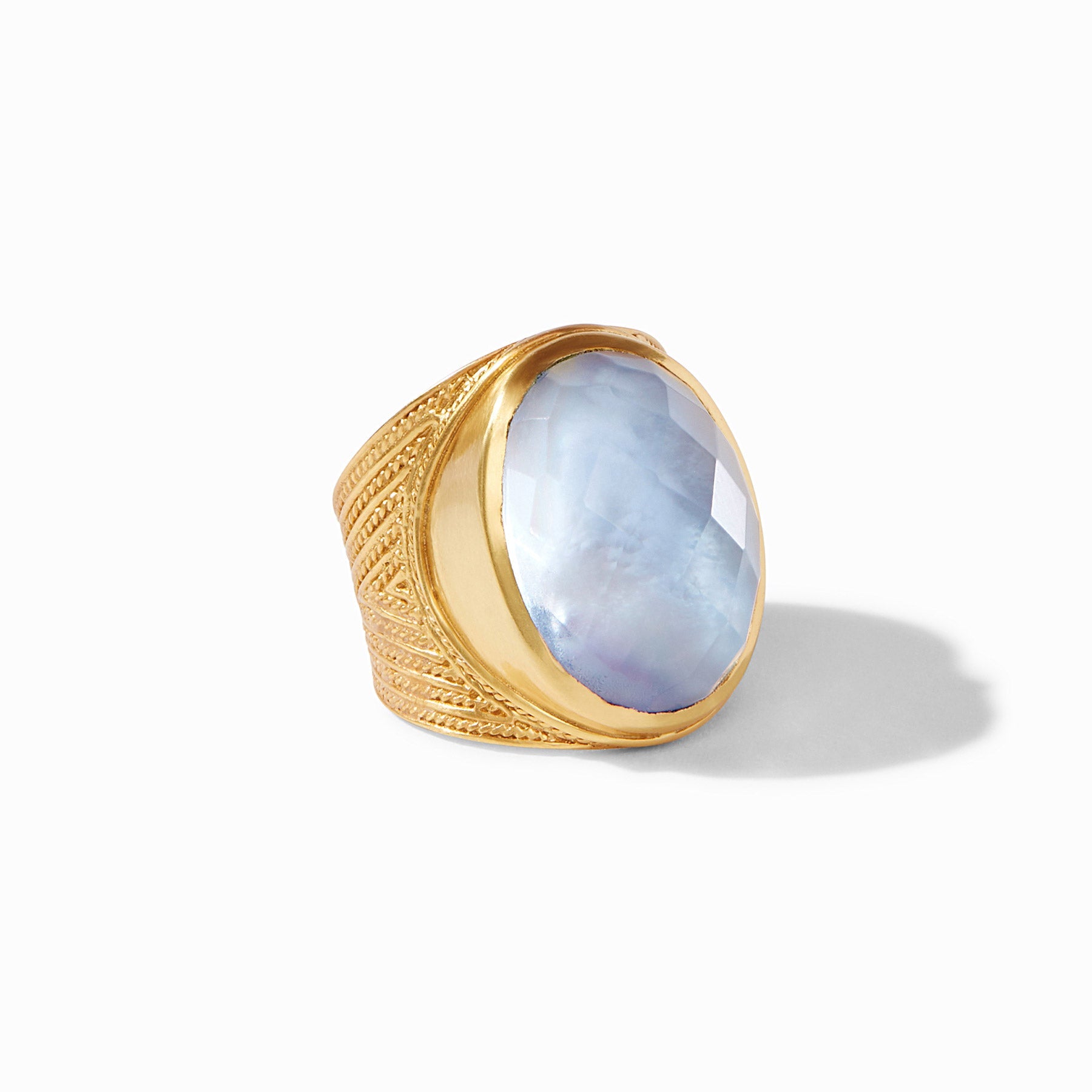 Gold ring with a blue stone on a white background