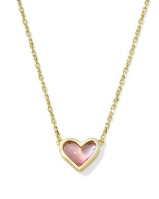 Heart-shaped pendant necklace with pink stone on a gold chain against a white background