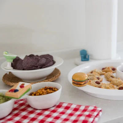 Table with various food items on a white surface with Nora Fleming Minis and Base Pieces 
