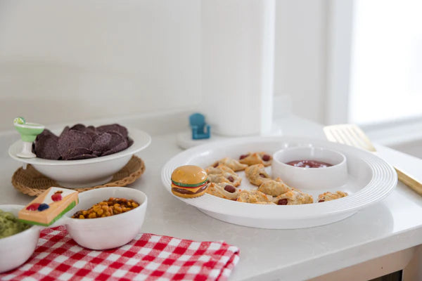 Table with various food items on a white surface with Nora Fleming Minis and Base Pieces 