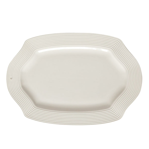 White ceramic platter with wavy edge on a white background