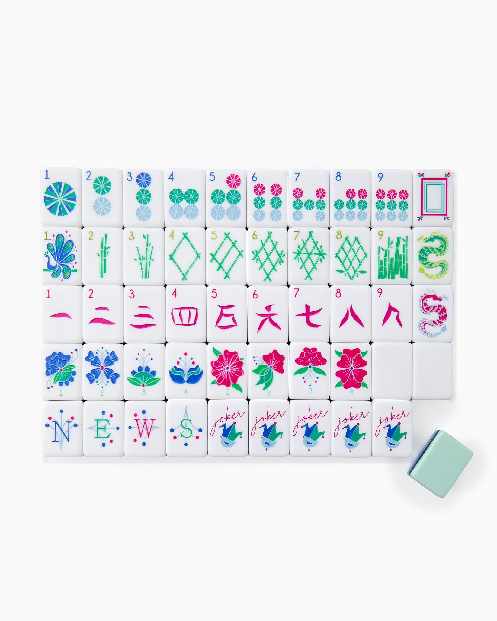 A set of colorful hand-painted Mahjong tiles arranged in a pattern, with a variety of geometric and natural designs, including birds and flowers, with a single tile slightly separated from the rest.
