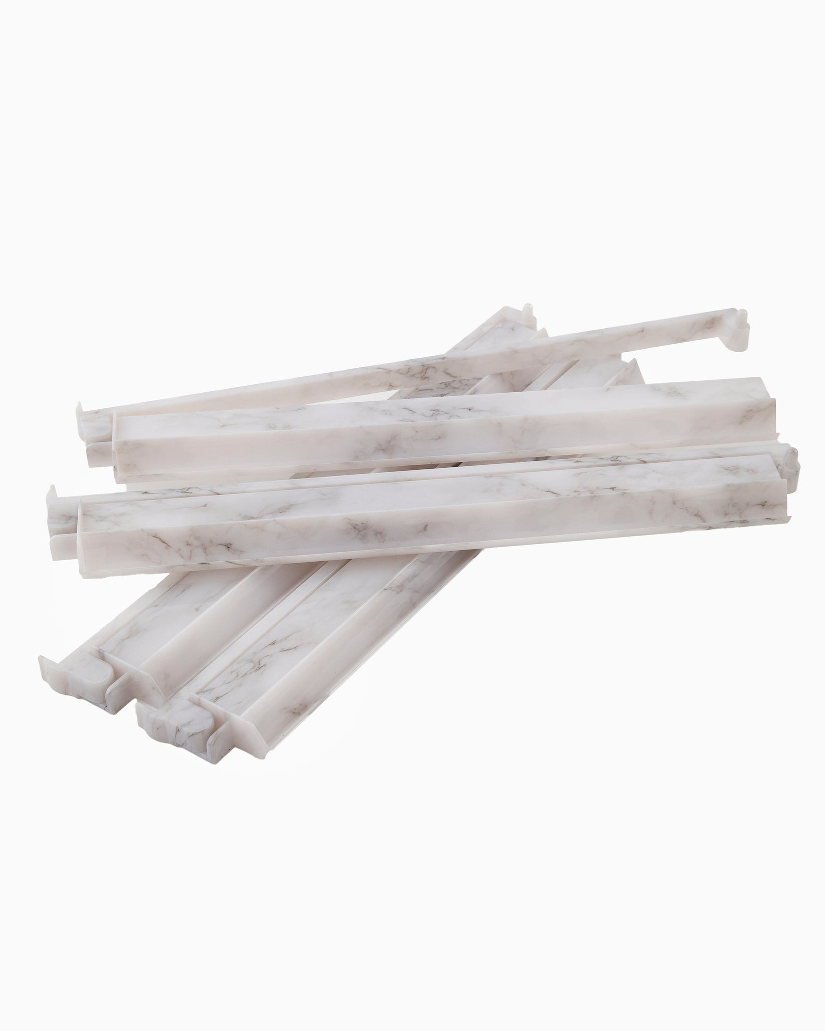 Stack of white marble-like sticks on a white background