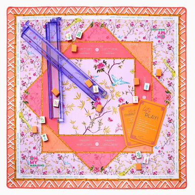 Floral-themed board game set with colorful components on a decorative board.