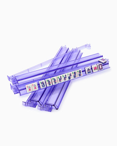 Stack of purple plastic straws with colorful labels on a white background