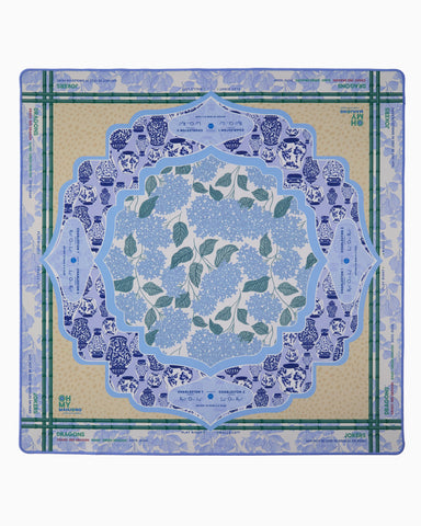 Decorative placemat with blue floral design on a beige background