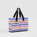 Striped tote bag with black handles on a light gray background