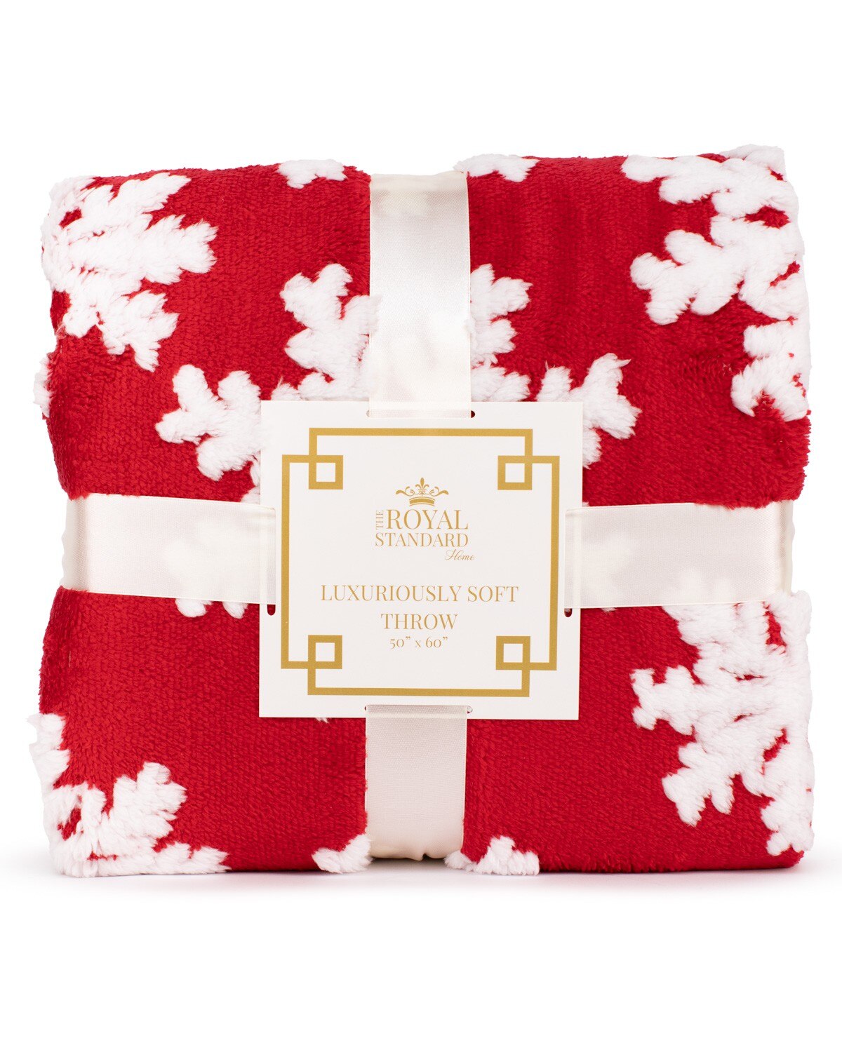 Folded red and white floral throw blanket with a visible brand label on a white background