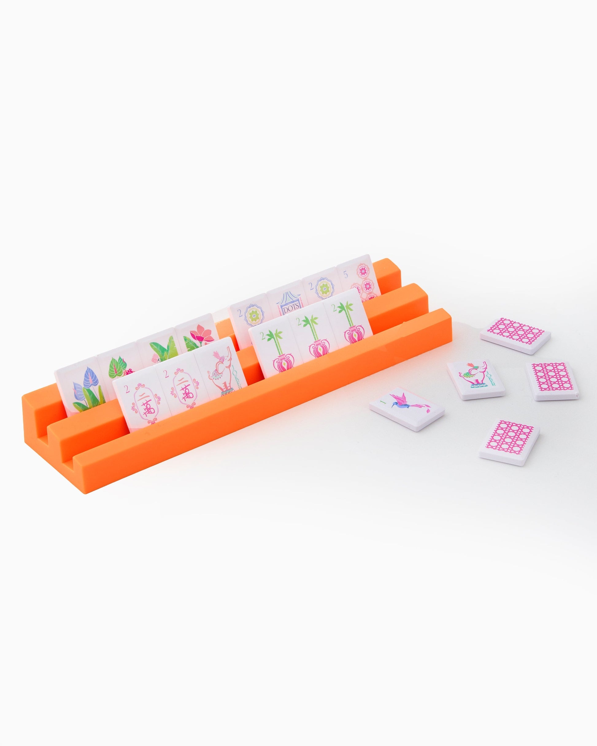 Set of tiles with floral designs in an orange holder on a white background