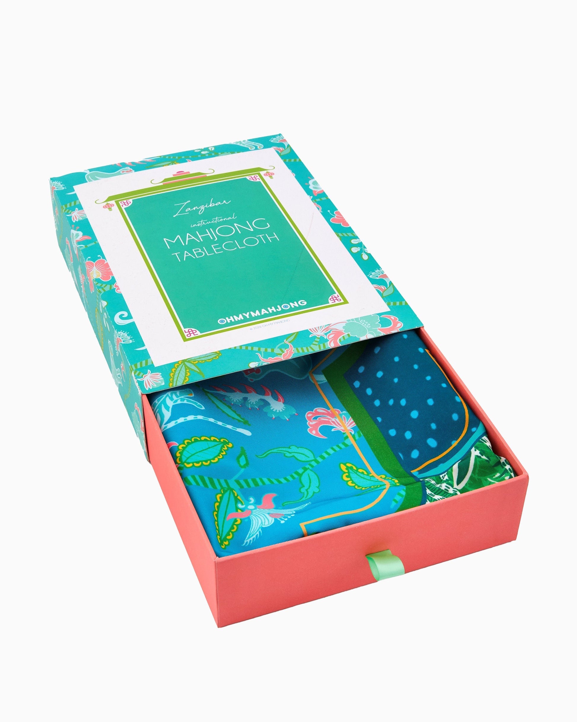 Boxed set of colorful tablecloths with decorative patterns on a white background