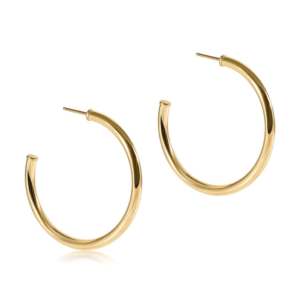 A pair of gold-colored post hoop smooth earrings with a gold-filled finish.