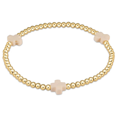 A gold-filled elastic bracelet with off-white beads and gold-filled bead caps.