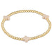A gold-filled elastic bracelet with off-white beads and gold-filled bead caps.