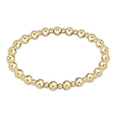 A gold-filled bracelet with alternating bead sizes, hand beaded on elastic.